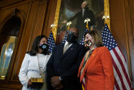 House Speaker Nancy Pelosi of Calif., right, poses for a photo during a ceremonial swearing-in for Rep. Troy Carter, D-La., center, as his wife Ana Carter, left, watches on Capitol Hill in Washington, Tuesday, May 11, 2021. (AP Photo/Susan Walsh)