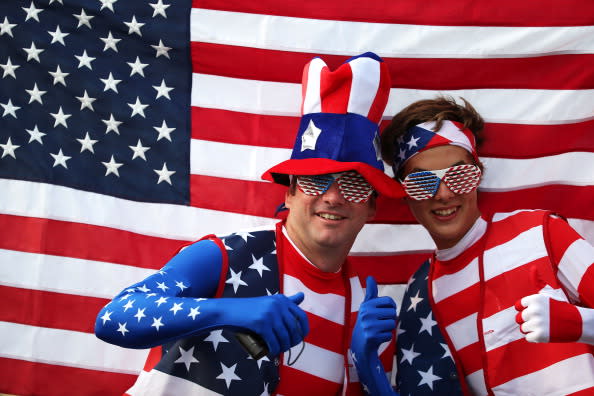 United States fans pose with their national flag outside the Olympic stadium during the Olympics Opening Day as part of the London 2012 Olympic Games at the Olympic Park on July 27, 2012 in London, England. (Photo by Jeff J Mitchell/Getty Images)