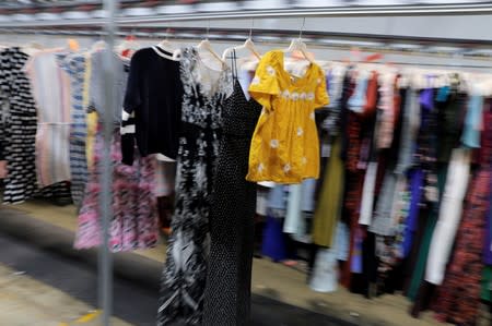 Garments travel toward the steam tunnel at Rent the Runway's "Dream Fulfillment Center" in Secaucus, New Jersey