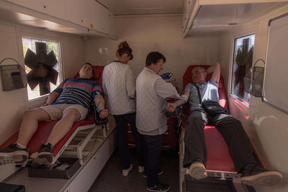 People donate their blood for the Ukrainian army in a mobile blood donation vehicle on June 3 in downtown Kyiv, Ukraine (Getty Images)