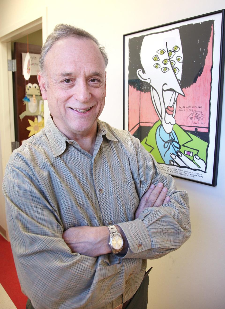 Dr. Mark Vonnegut, Milton resident and Quincy pediatrician, is pictured on Nov. 19, 2013 with a piece of his dad's art work.