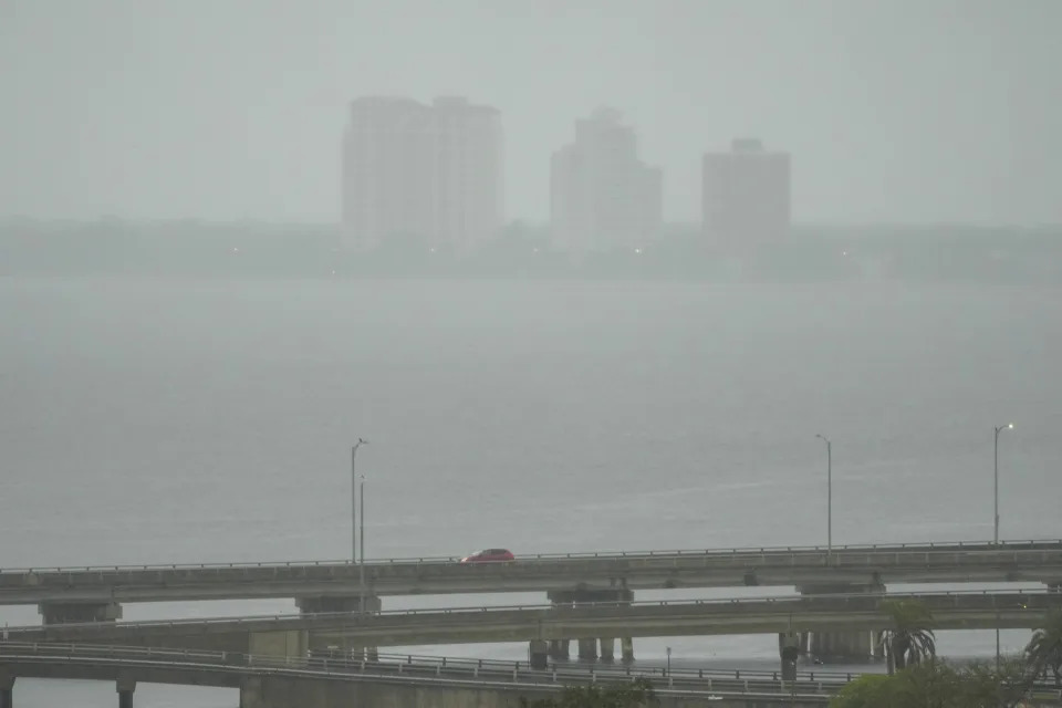 A vehicle crosses a bridge as rain begins to fall ahead of the arrival of Hurricane Milton, Wednesday, Oct. 9, 2024, in Tampa, Fla. (AP Photo/Julio Cortez)