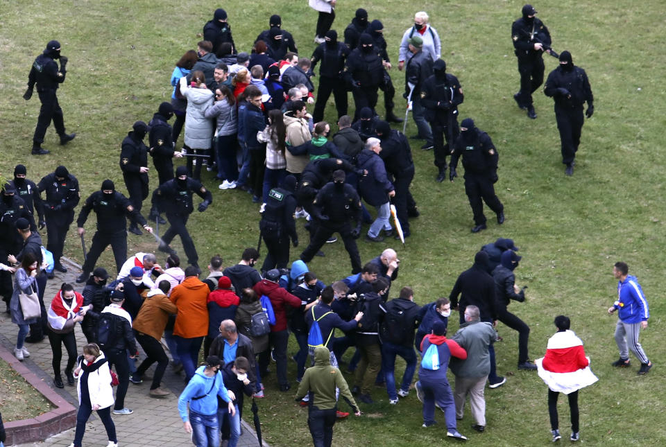 People clash with policemen during an opposition rally to protest the official presidential election results in Minsk, Belarus, Sunday, Oct. 11, 2020. Hundreds of thousands of Belarusians have been protesting daily since the Aug. 9 presidential election. (AP Photo)