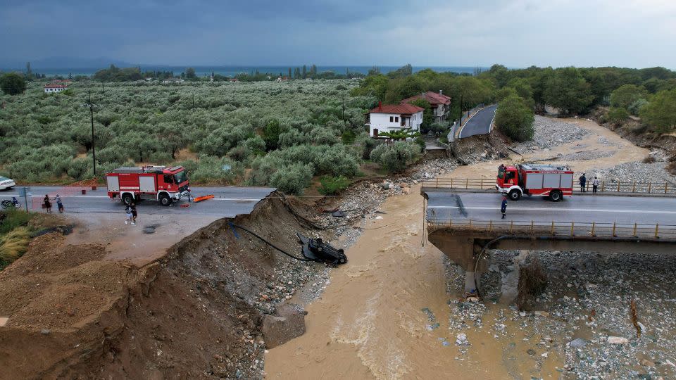 Firefighting crews are seen on a collapsed bridge in the village of Kala Nera, in central Greece, September 7 2023. - Stamos Prousalis/Reuters