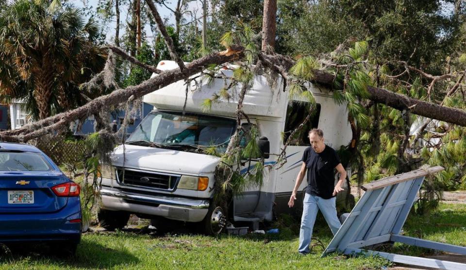 Patrick Brower, 71, inspects the damage to his car and camper in Perry on Wednesday.