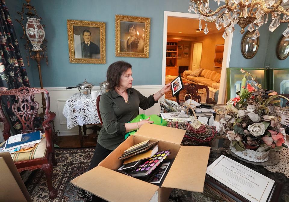 Lisa Tawil sorts through boxes of memories at her parent's house in Tampa on April 28, 2022.