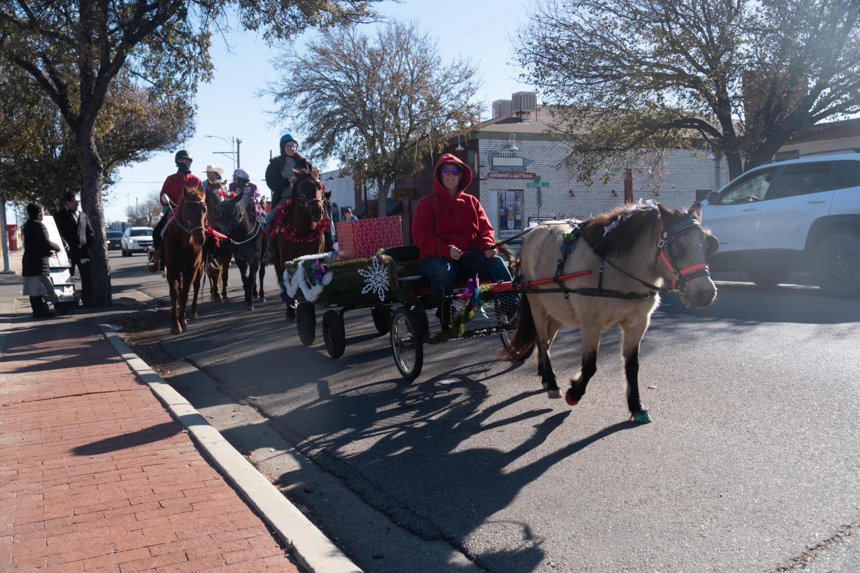 Riders from the Panhandle Trail Riders association ride down 6th Avenue to deliver toys for the 11th Annual Toy Drive Saturday morning in the historic Route 66 Amarillo District.