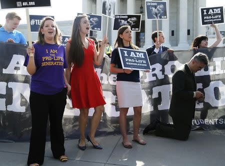 Anti-abortion rights protesters sing, chant and pray as they demonstrate outside the U.S. Supreme Court in Washington June 30, 2014. REUTERS/Jonathan Ernst