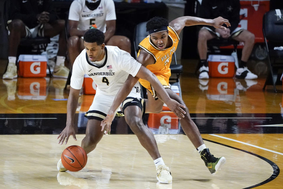 Vanderbilt guard Jordan Wright (4) protects the ball from Valparaiso guard Donovan Clay, right, in the first half of an NCAA college basketball game Friday, Nov. 27, 2020, in Nashville, Tenn. (AP Photo/Mark Humphrey)