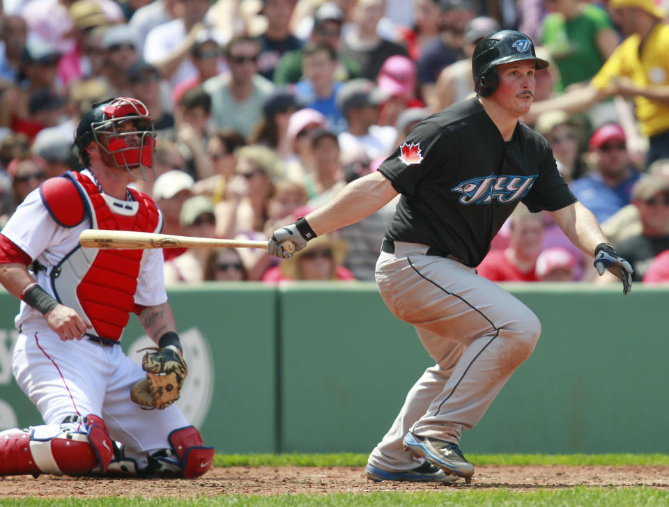 Toronto Blue Jays' Travis Snider, right, watches his double in front of Boston Red Sox's Jarrod Saltalamacchia in the third inning of a baseball game in Boston, Monday, July 4, 2011. The Blue Jays won 9-7. (AP Photo/Michael Dwyer)