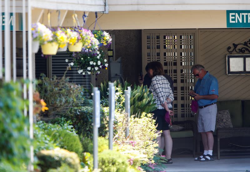 People stand outside Life Care Center of Kirkland, a long-term care facility linked to several coronavirus disease (COVID-19) deaths in Kirkland