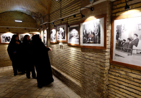 Iranian pilgrims look at the pictures of the late Iranian revolutionary leader Ayatollah Ruhollah Khomeini, at the former home of Khomeini in Najaf, Iraq February 9, 2019. Picture taken February 9, 2019. REUTERS/Alaa al-Marjani