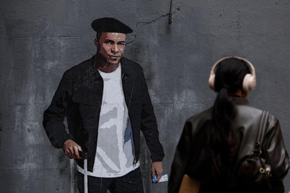 This photograph taken on 30 April shows a mural called The Mbappe Law by Italian urban artist Salvatore Benintende aka 