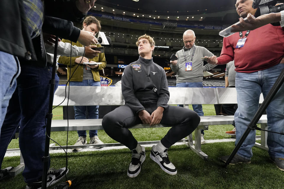 Texas quarterback Arch Manning talks to reporters during media day for the the upcoming Sugar Bowl NCAA CFP college football semi-final game against Washington in New Orleans, Saturday, Dec. 30, 2023. (AP Photo/Gerald Herbert)