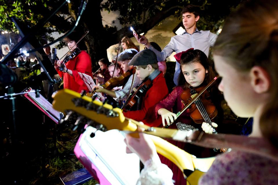 Dec 6, 2022; Tuscaloosa, Alabama, USA;  Northport hosted the annual Dickens Downtown on Main Ave. Tuesday, kicking off the Christmas season. Young fiddle students led by Sharon Bound play in front of the Shirley Place. 