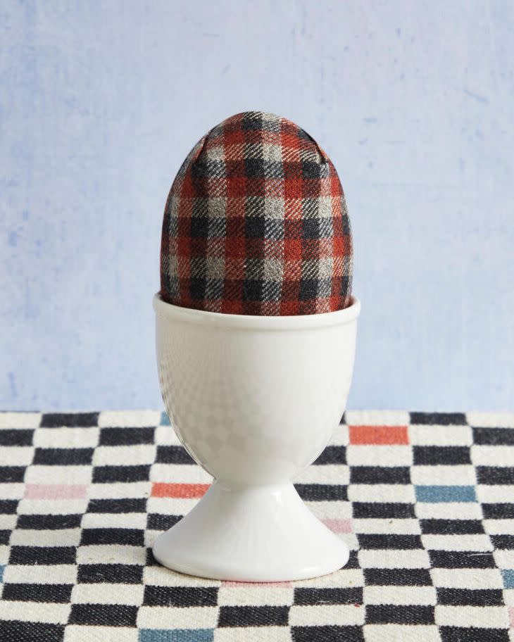 an easter egg decorated in plaid for taylor swift's evermore album