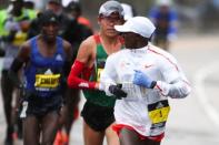 Apr 16, 2018; Boston, MA, USA; Geoffrey Kirui looks back at Yuki Kawauchi on the 2018 Boston Marathon course. Mandatory Credit: Paul Rutherford-USA TODAY Sports