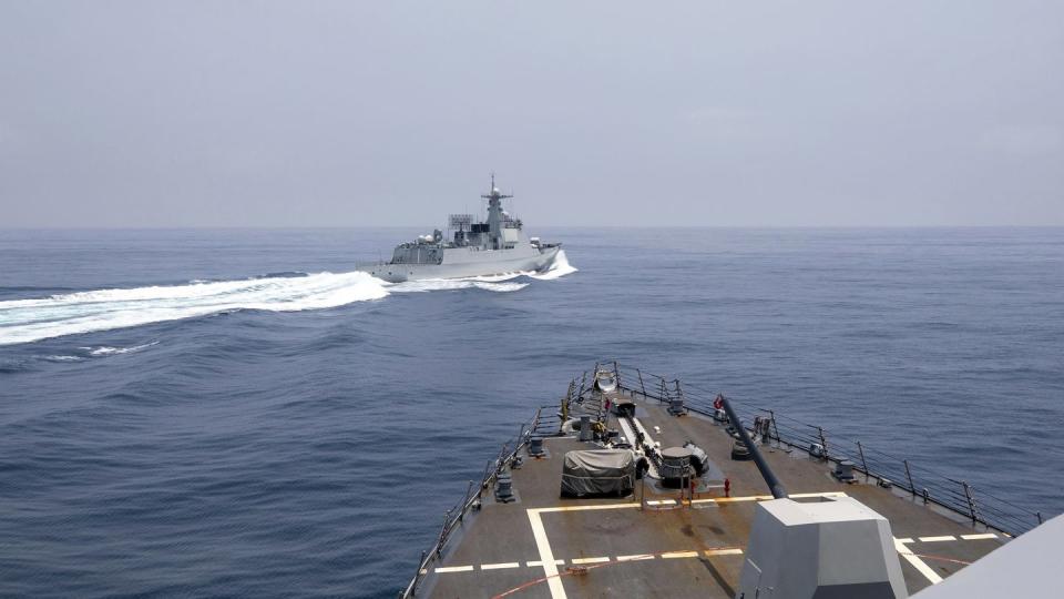 In this photo provided by the U.S. Navy, the guided-missile destroyer Chung-Hoon observes a Chinese navy ship conduct what it called an 