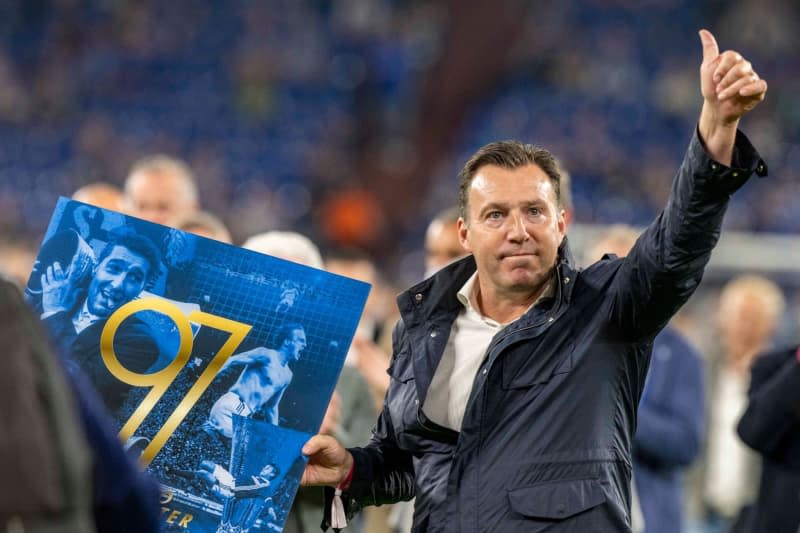 Belgian football manager Marc Wilmots shows the award for the 25th anniversary of the 1997 Uefa Cup victory. Fan favourite Marc Wilmots is returning to Schalke as sporting director, the German second division club said on Thursday. David Inderlied/dpa