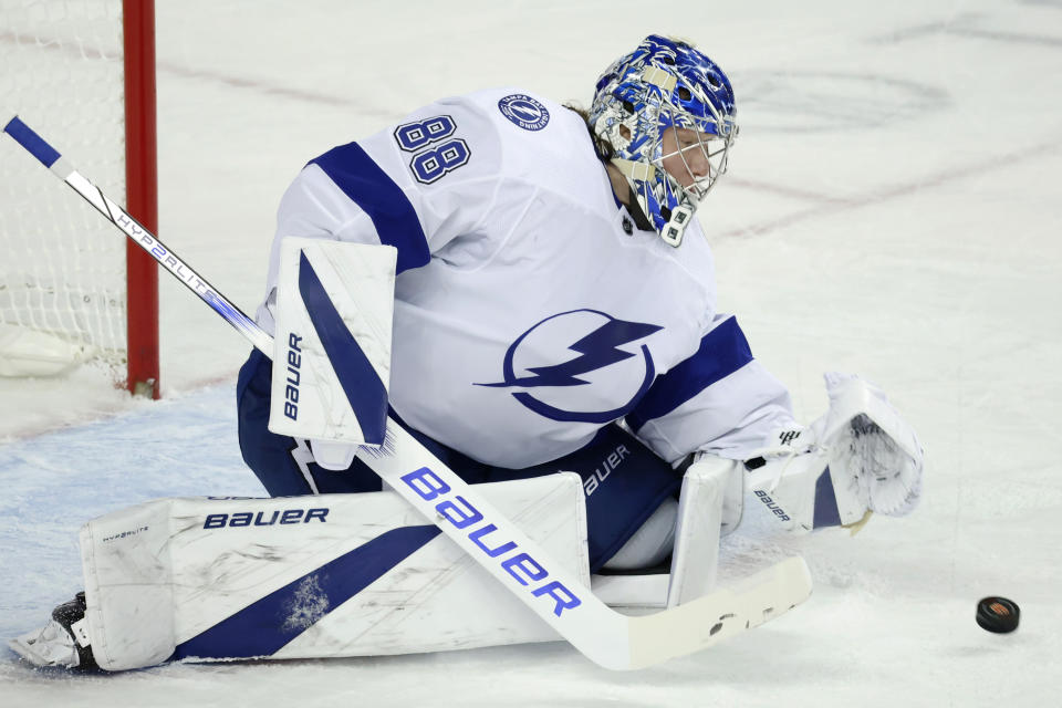 Tampa Bay Lightning goaltender Andrei Vasilevskiy (88) makes a save against the Calgary Flames during the first period of an NHL hockey game Saturday, Dec. 16, 2023, in Calgary, Alberta. (Larry MacDougal/The Canadian Press via AP)