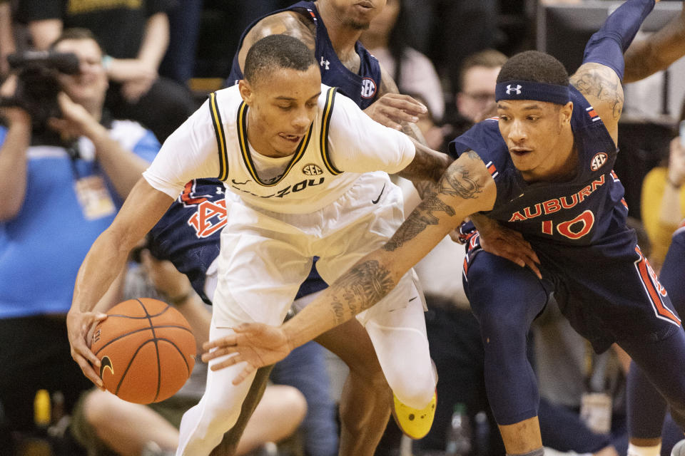 Auburn's Samir Doughty, right, tries to steal the ball from Missouri's Xavier Pinson, left, during the first half of an NCAA college basketball game Saturday, Feb. 15, 2020, in Columbia, Mo. (AP Photo/L.G. Patterson)