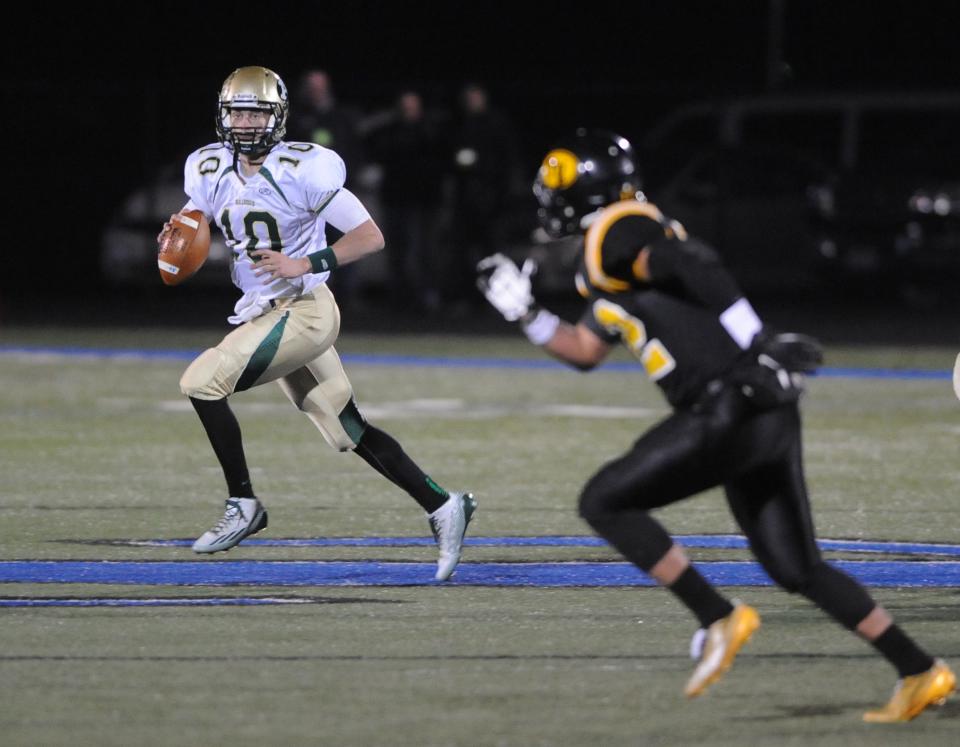 Athens quarterback Joe Burrow looks to pass Nov. 14 during a regional semifinal playoff game against Tri-Valley at Zanesville High School. Athens defeated Tri-Valley, 41-20.