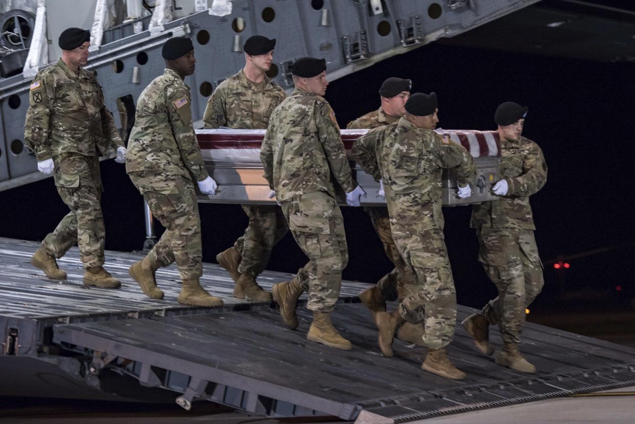 Soldiers from the Third U.S. Infantry Regiment carry the transfer case during a “casualty return” for Staff Sgt. Dustin M. Wright, of Lyons, Ga., at Dover Air Force Base, Del. (Photo: Pfc. Lane Hiser/U.S. Army via AP)