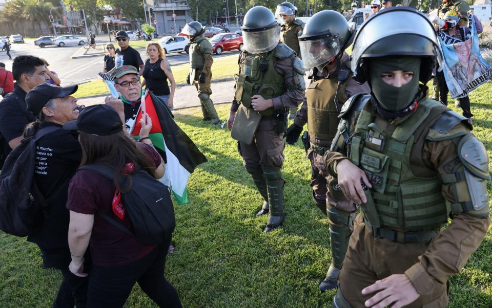 Riot police officers disperse people