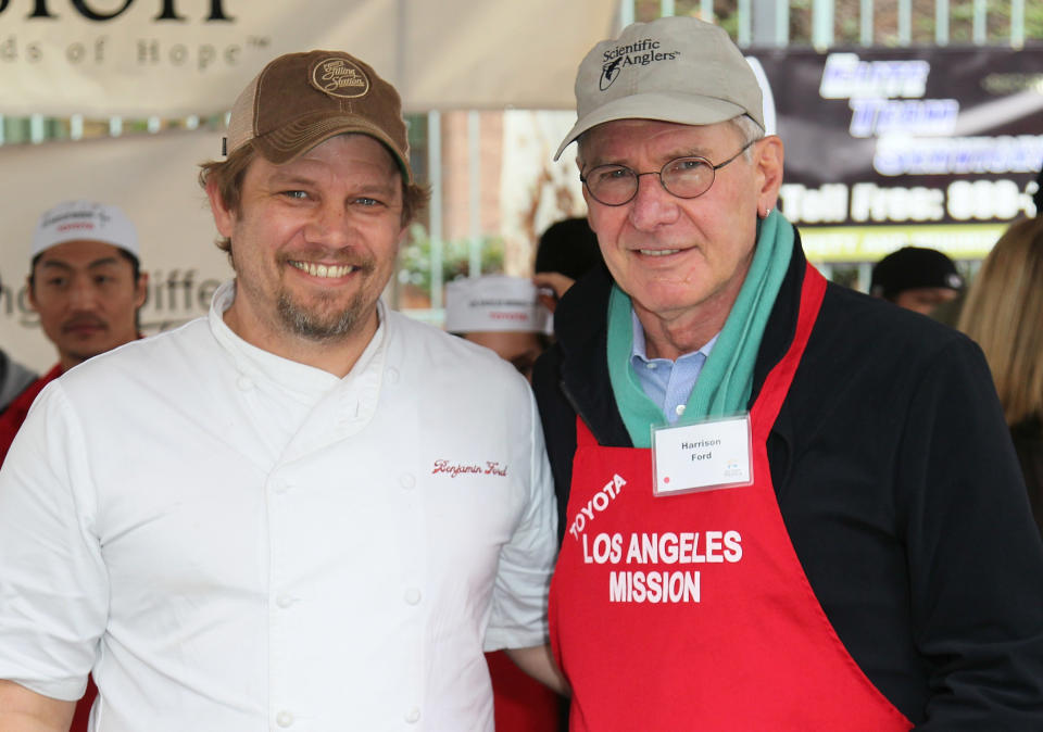 Chef Ben Ford (L) and father actor Harrison Ford attend the Los Angeles Mission's Christmas Eve for the homeless at the Los Angeles Mission on December 24, 2012