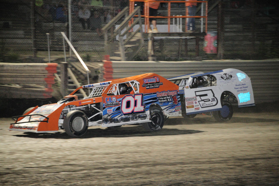 Colton Shaw (01) and Mark Baier (3JR) battle for the lead during Modified racing action at Hilltop Speedway. Shaw scored his 5th feature win of the year, finishing ahead of Baier.