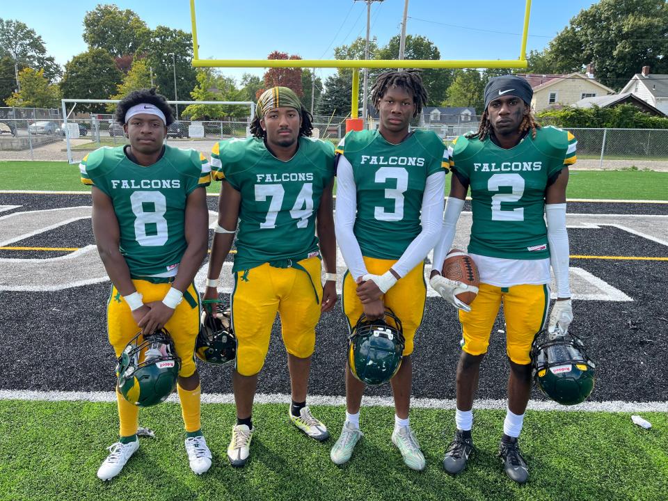 Firestone football players, from left to right, Daniel Peterson, Cupid Atkins, Kahlil Hayden and Matthew White pose for a photo after a win over Garfield on Sept. 23.