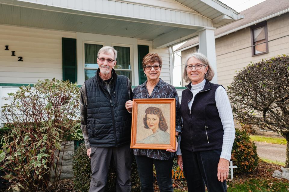Jeff Beaber, Sherie Reese and Patty Burson, from left, pose with a portrait of Betty Beaber, who died in 1965. The portrait was painted by a German prisoner of war During World War II. Beaber's husband was a POW prison guard in Tennessee, where some prisoners were held during war time. He died Sunday, Nov. 5, at 101 years old.