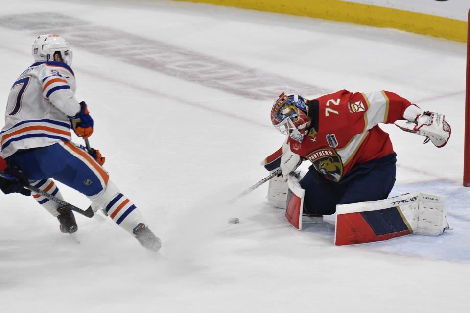 Florida Panthers goaltender Sergei Bobrovsky (72) stops a shot by Edmonton Oilers center Connor McDavid (97) during the third period of Game 2 of the NHL hockey Stanley Cup Finals, Monday, June 10, 2024, in Sunrise, Fla. (AP Photo/Michael Laughlin)