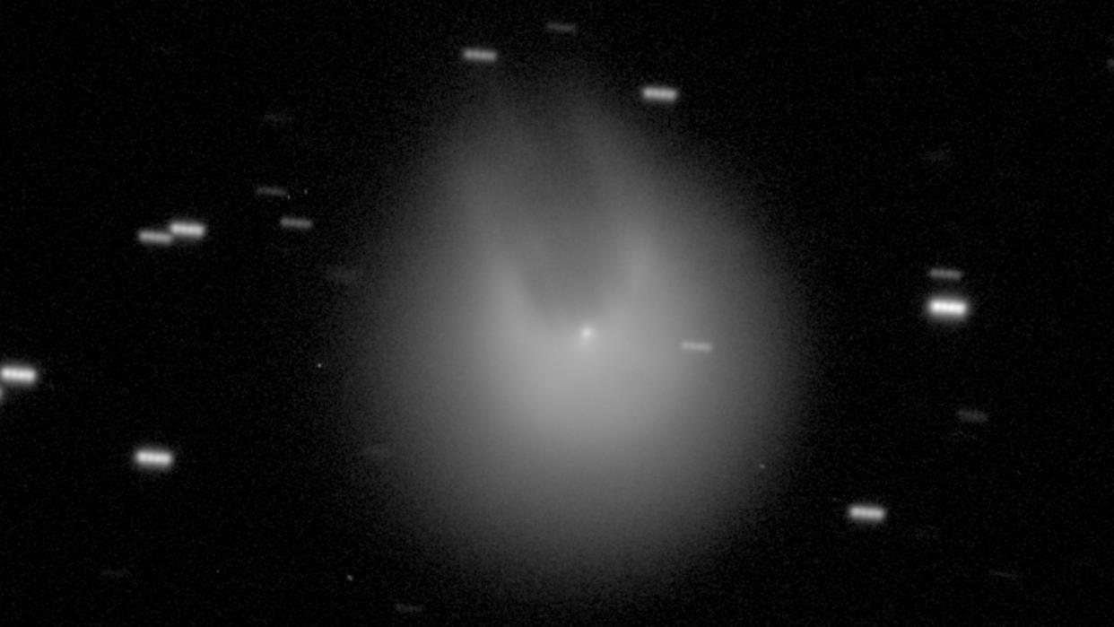  A blurry image of a comet that appears to have two horns 