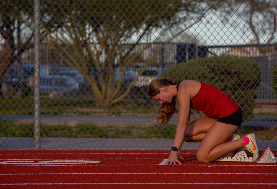 Makenna Topp sets up on a starting block for the 200-meter dash during a 3-way track meet on the Boulder Creek High School track in Anthem on March 29, 2023.