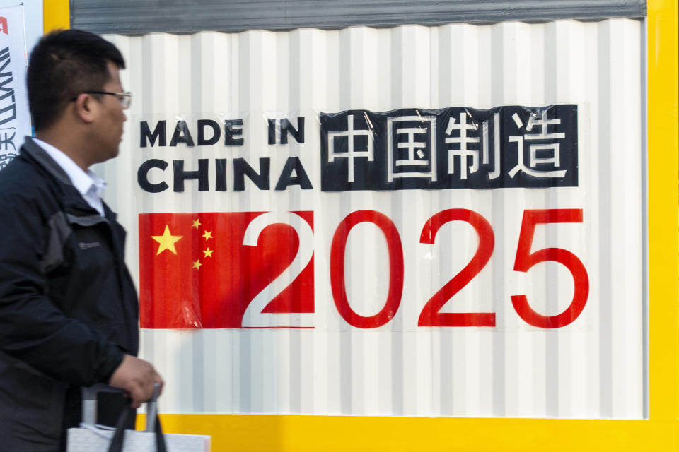 A man passes a symbol reading “Made in China 2025” during a 2018 manufacturing expo in Shanghai. (Photo: VCG/VCG via Getty Images)