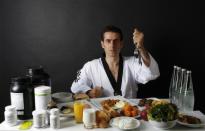 Turkish Taekwondo fighter and Olympic hopeful Bahri Tanrikulu, 32, poses in front of his daily meal intake in Ankara May 24, 2012.