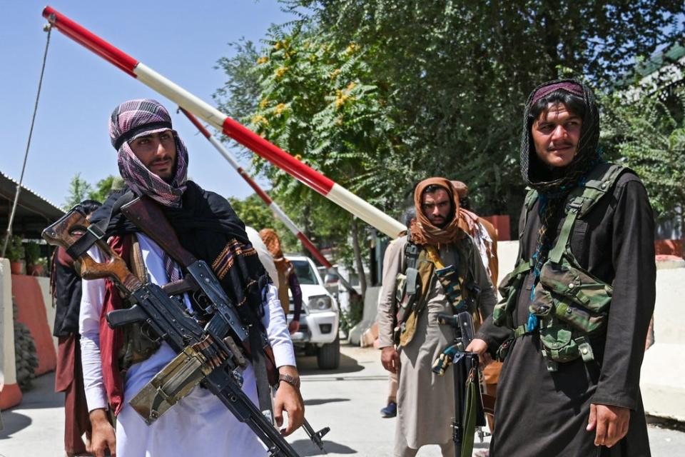Taliban fighters stand guard along a roadside near the Zanbaq Square in Kabul on August 16, 2021, after a stunningly swift end to Afghanistan’s 20-year war (AFP via Getty Images)