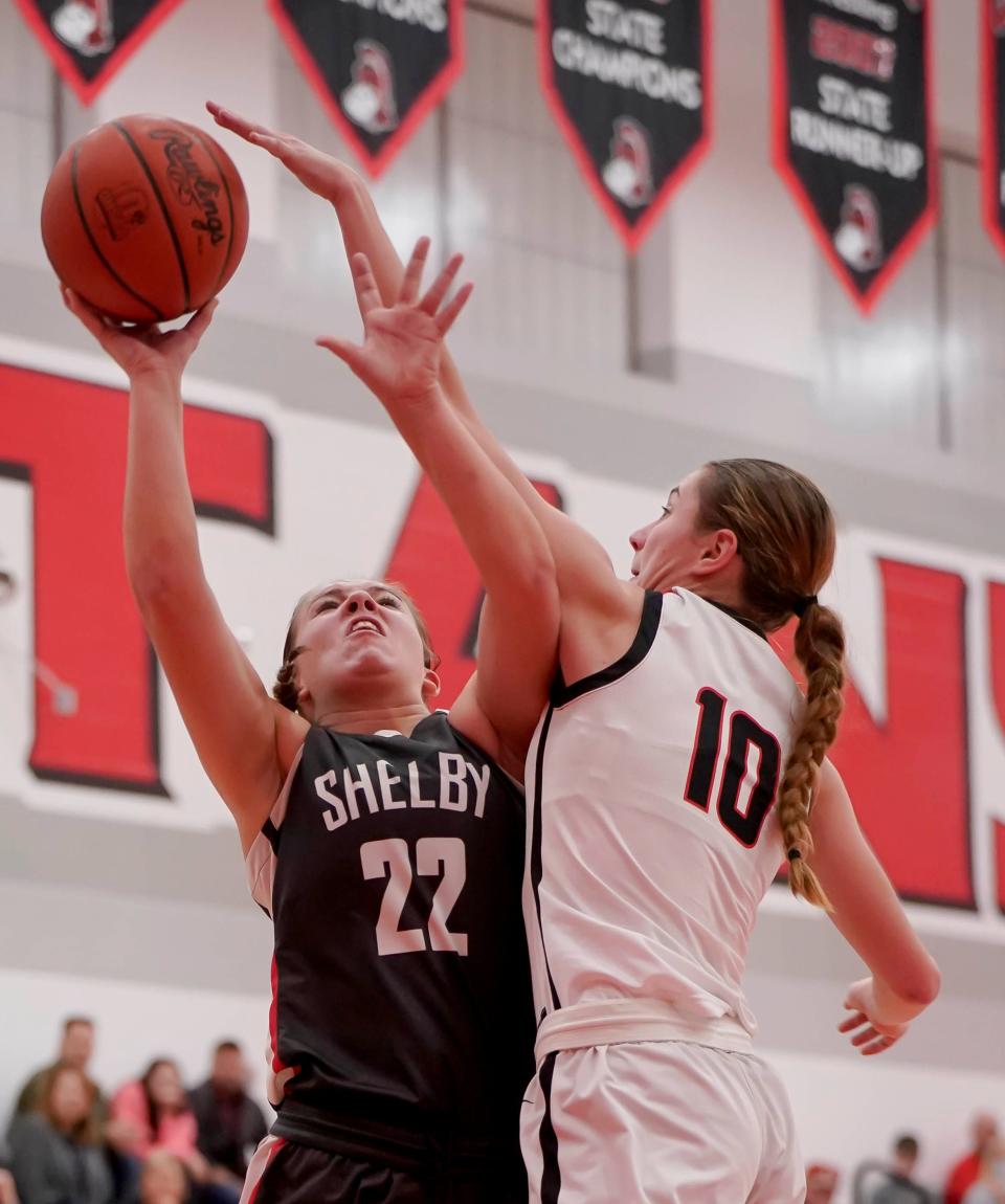 Pleasant's Whitney Waddell attempts to block the shot of Shelby's Eve Schwemley during a key Mid Ohio Athletic Conference girls basketball game last week.