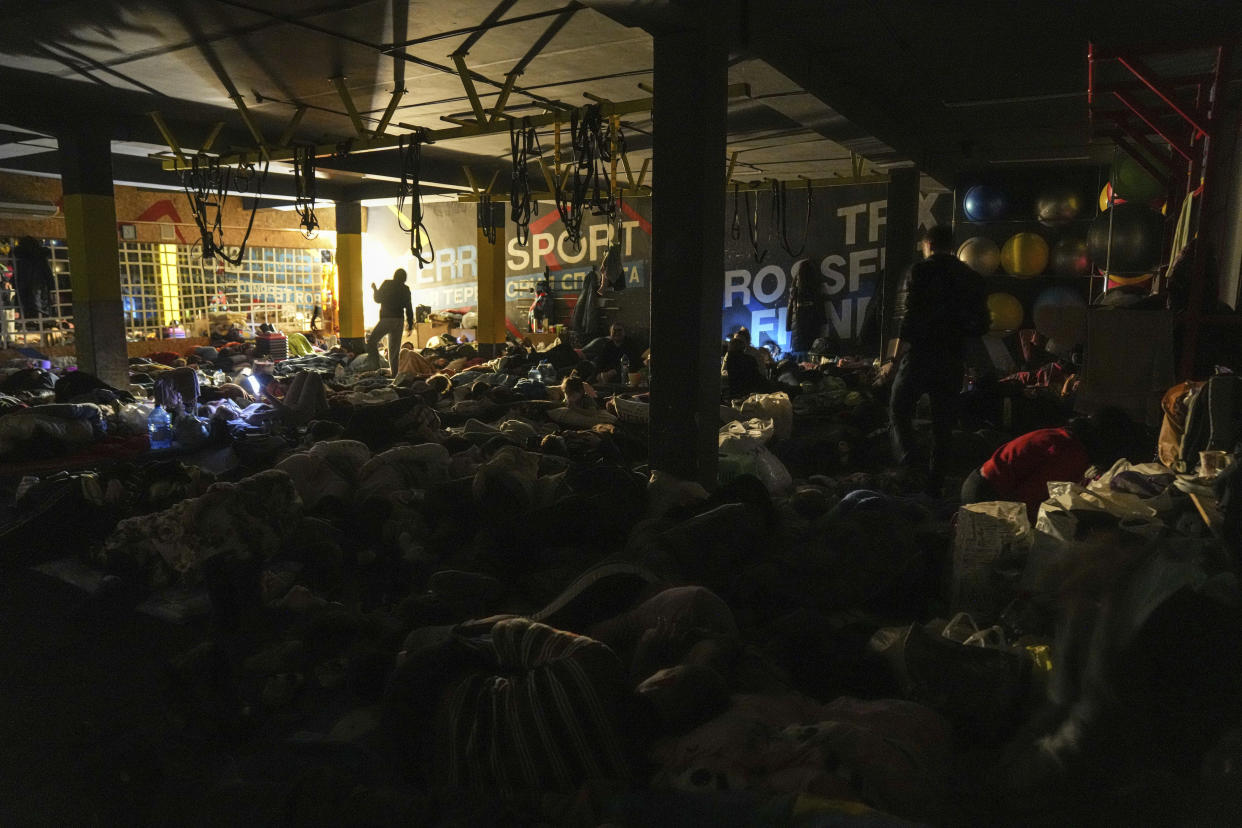 People prepare for the night in the improvised bomb shelter in a sports center that can accommodate up to 2,000 people in Mariupol, Ukraine, on Feb. 27.  (Evgeniy Maloletka / AP)
