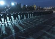 Police block the central square in Ulan-Ude, the regional capital of Buryatia, a region near the Russia-Mongolia border, Russia, Wednesday, April 21, 2021. Navalny's team has called for nationwide protests on Wednesday following reports that the politician's health was deteriorating in prison, where he has been on hunger strike since March 31. Russian authorities have stressed that the demonstrations were not authorized and warned against participating in them. (AP Photo/Anna Ogorodnik)