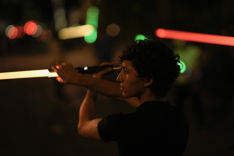 A Jedi Knight Academy student learns to use a lightsaber at a park in Mexico City, late Thursday, June 20, 2024. The academy is a lightsaber combat and choreography school founded in 2019 and a dream come true for fans of Star Wars. (AP Photo/Eduardo Verdugo)