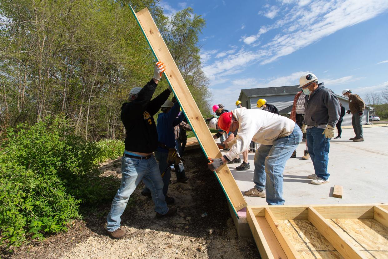 Volunteers raise a wall as Rockford Area Habitat for Humanity begins its 2021 construction season on May 1, 2021, in the Brandon subdivision in Rockford. Rockford Area Habitat for Humanity is teaming with the city of Rockford and the Rockford Housing Development Corp. on a home repair program.