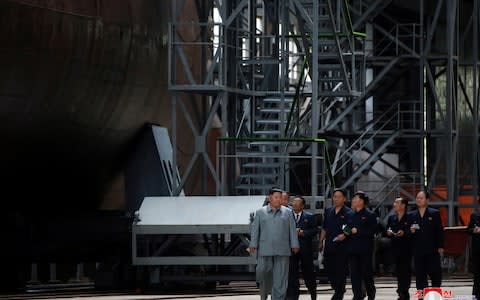 North Korean leader Kim Jong Un visits a submarine factory in an undisclosed location, North Korea - Credit: Reuters