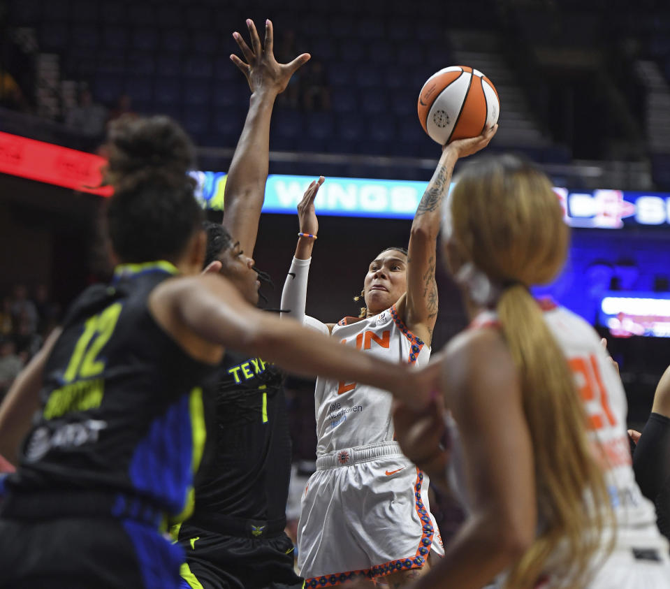 Connecticut Sun guard Natisha Hiedeman (2) shoots against Dallas Wings center Teaira McCowan (7) during Game 1 of a WNBA basketball first-round playoff series Thursday, Aug. 18, 2022, in Uncasville, Conn. (Sean D. Elliot/The Day via AP)