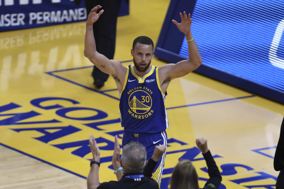Golden State Warriors' Stephen Curry waves to the crowd after scoring against the Oklahoma City Thunder during the first half of an NBA basketball game in San Francisco, Saturday, May 8, 2021. (AP Photo/Jed Jacobsohn)