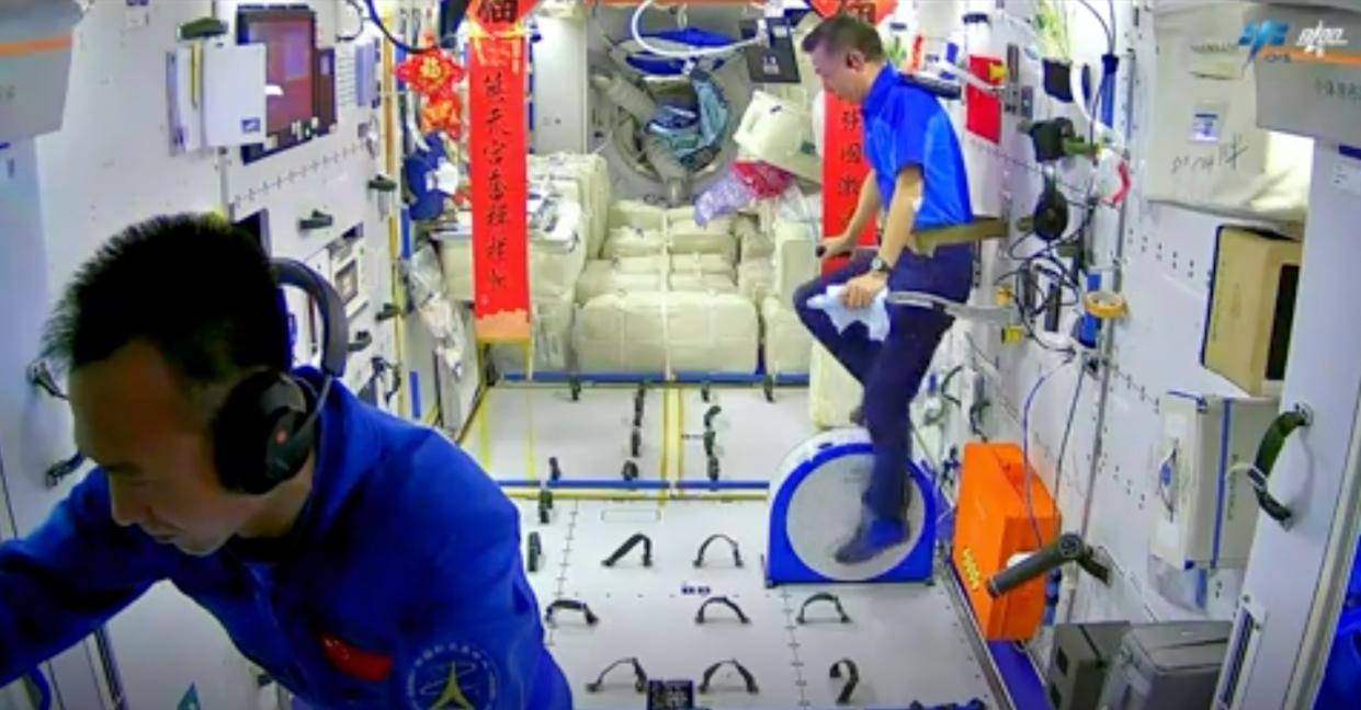  Shenzhou 15 astronauts Deng Qingming and Zhang Lu get in a workout aboard China's Tiangong space station. 