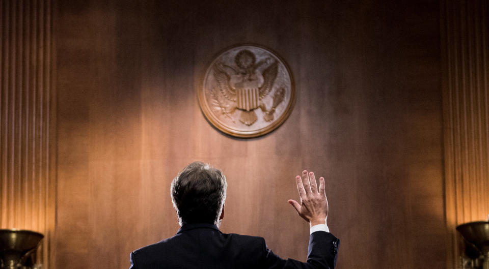 Kavanaugh is sworn in before testifying.