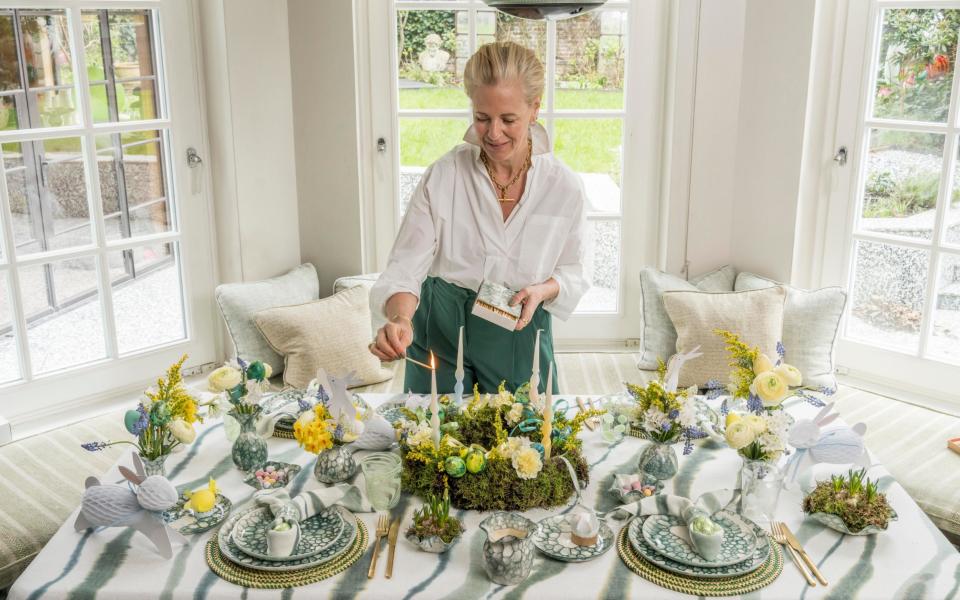 Deborah Brett lights the candles on her home-made spring wreath