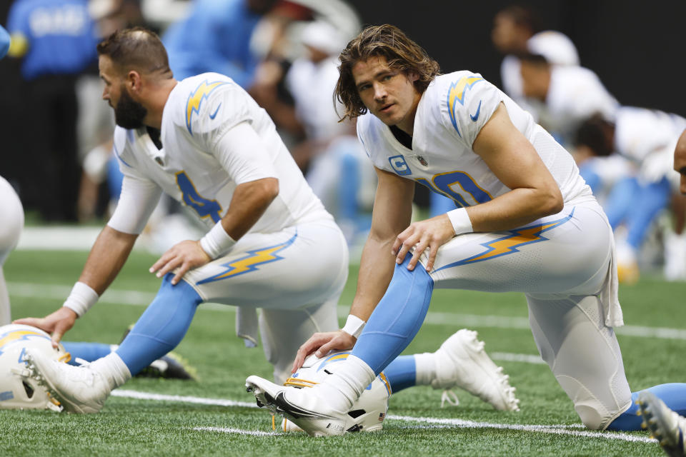 CORRECTS DATE TO SUNDAY, NOV. 6 INSTEAD OF TUESDAY, DEC. 6 - Los Angeles Chargers quarterback Justin Herbert (10) stretches before an NFL football game against the Atlanta Falcons, Sunday, Nov. 6, 2022, in Atlanta. (AP Photo/Butch Dill)